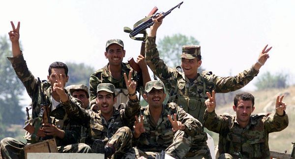 A Syrian army truck carrying troops who are give V for victory signs at the mountain village of Alley on their way to the eastern Bekaa valley Thursday June 14, 2001. The Syrian army has started redeploying some of its troops from Beirut's mainly Christian neighborhoods. (AP Photo/str)